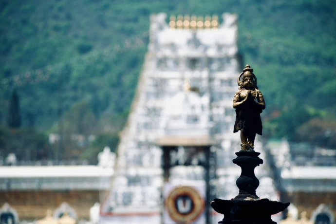 A statue is shown against a temple.